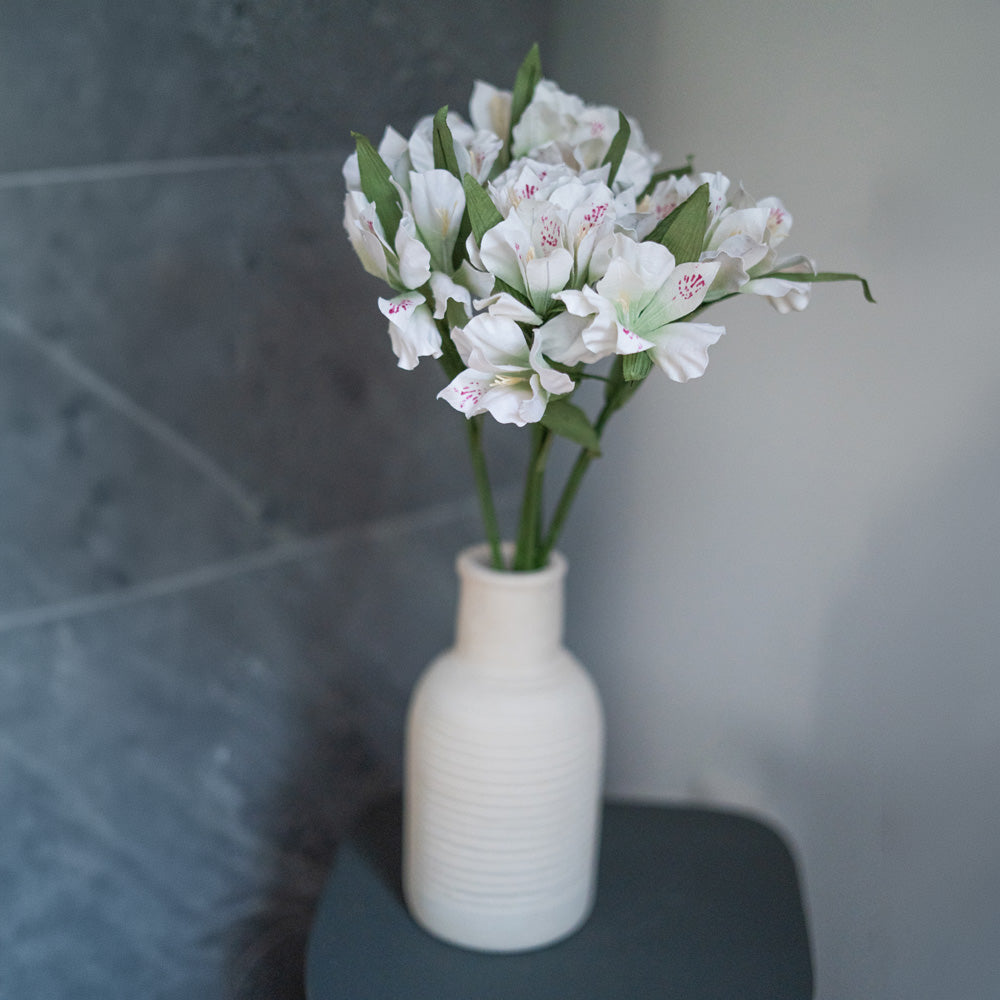 Inca lilies in white and green paper
